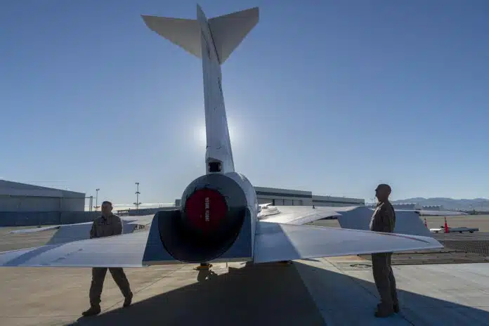 NASA and Lockheed Martin test pilots inspect the painted X-59 as it sits on the ramp at Lockheed Martin Skunk Works in Palmdale, California.